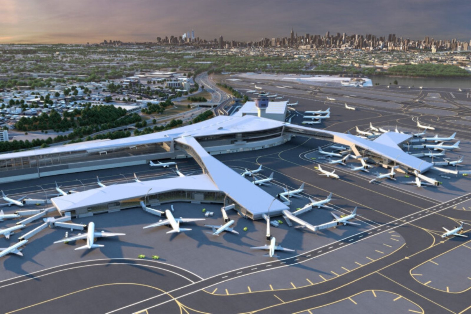 Aerial view of sprawling LaGuardia airport with many parked airplanes, runways, and taxiways, backed by wetlands and a distant city skyline.