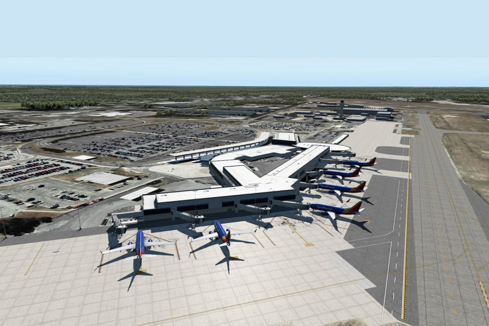 Aerial view of a modern airport terminal with multiple parked passenger jets, taxiways, runways, and cars under a clear blue sky.
