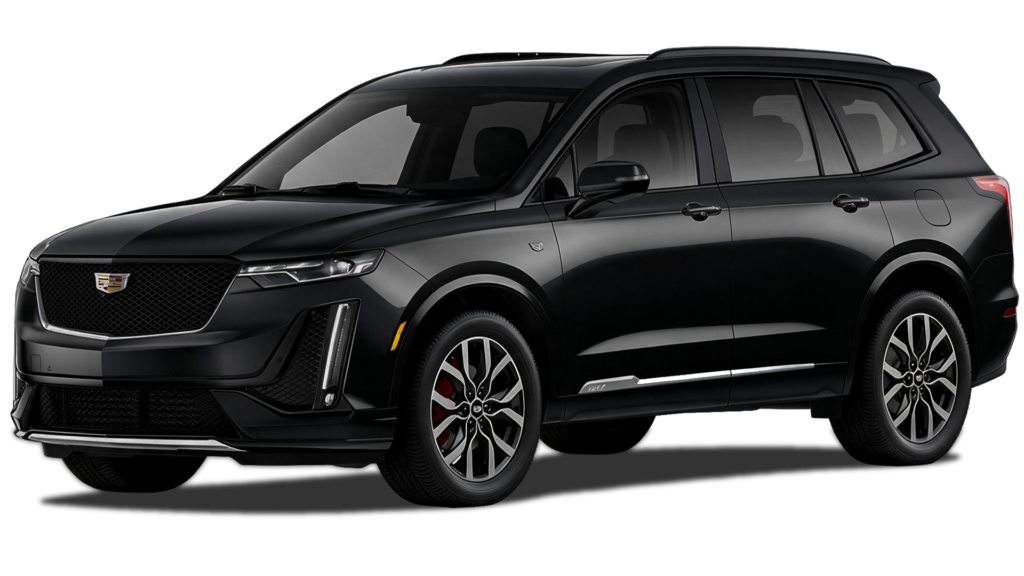 Black Cadillac XT6 midsize luxury three-row SUV in three-quarter front view, highlighting its bold grille, LED lights, sculpted body, alloy wheels, and sleek design.