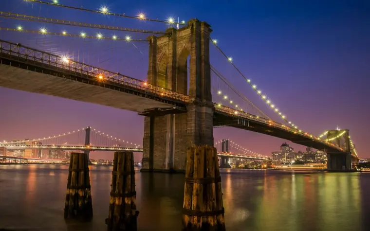 Brooklyn Bridge lit up at dusk
