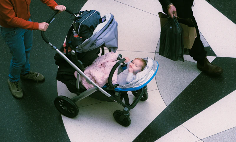 Parent pushing a baby in a stroller