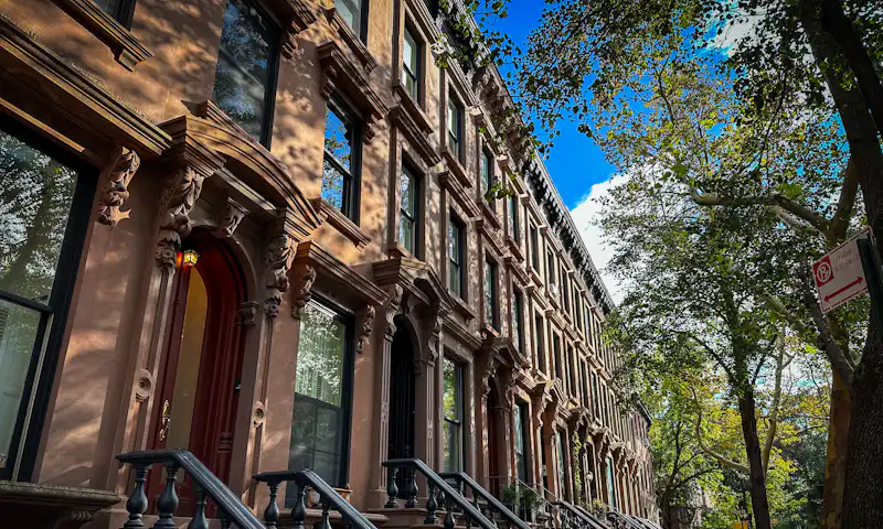 Row of brownstones with stoops on a Brooklyn street